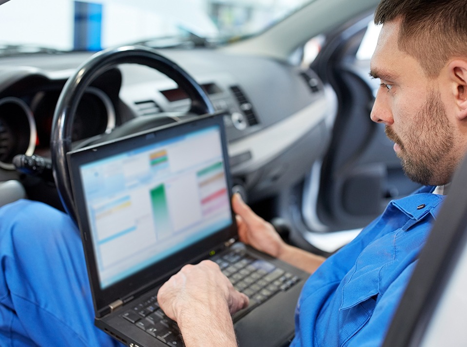 Mechanic looking over a computer - Car Diagnostics Middlesbrough